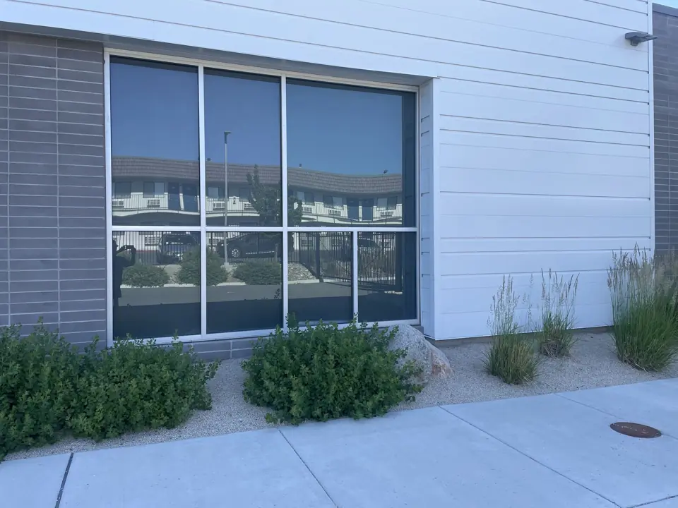 Before: Commercial storefront window, solar screens
