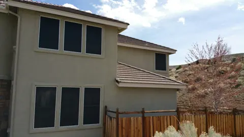 Two-story Reno-Sparks home with dark solar screens on every window